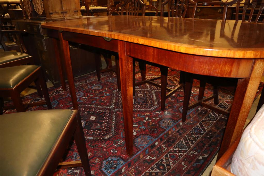 A Georgian style satinwood-banded mahogany D-end dining table with additional leaf, 195cm extended and a set of eight Hepplewhite style